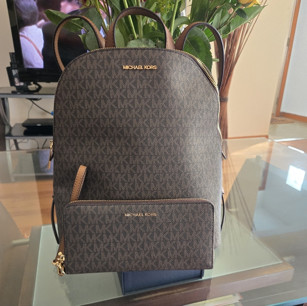 Michael Kors Signature Brown Backpack with matching wallet.